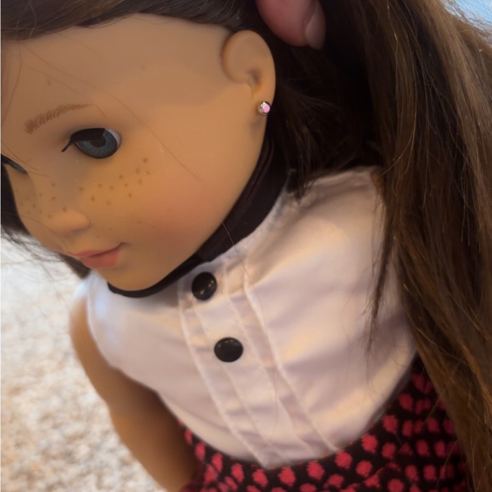 Brown-Haired American Girl Doll with Pink Stud Earrings and White Collar Dress